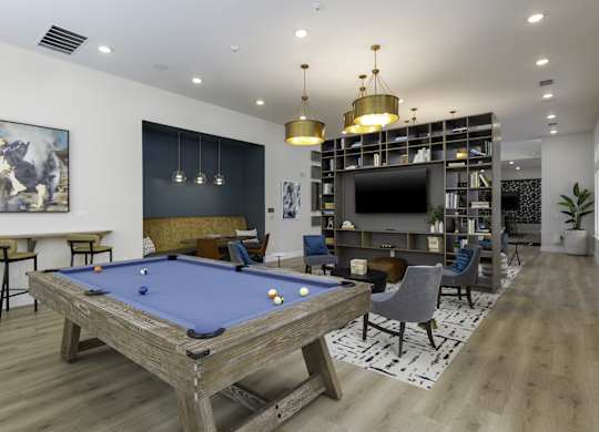 a clubhouse with a pool table and a tv