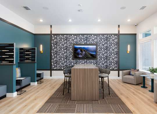 a conference room with a table and chairs and a tv on the wall