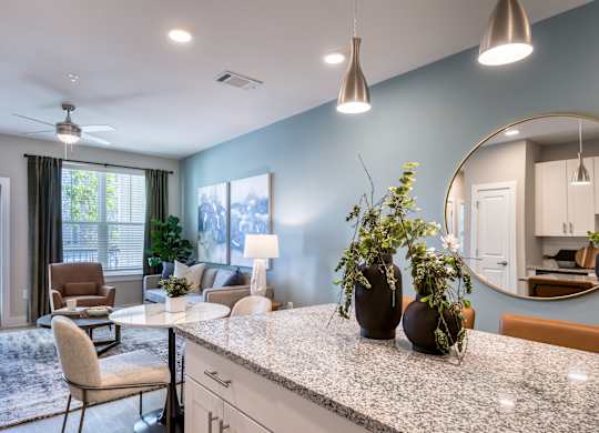 A kitchen with a table and chairs and a fan.