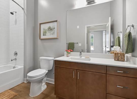 A white toilet sits in a bathroom next to a white sink.