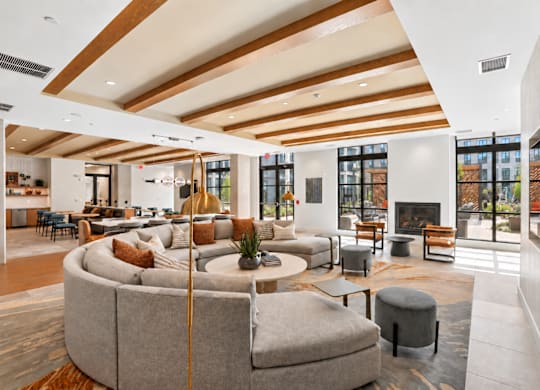 A modern living room with a curved sofa and a fireplace.