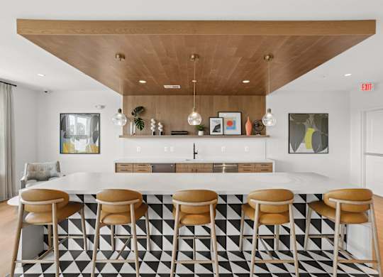 A black and white checkered floor in a room with a bar.