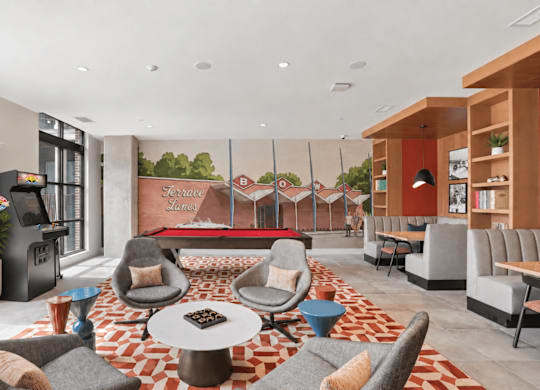 A living room with a red and white patterned carpet and grey chairs.