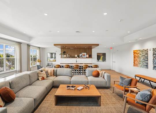 A living room with a grey sofa and a wooden coffee table.