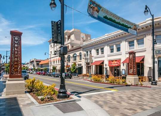 A street view of a sunny day with a clear blue sky.