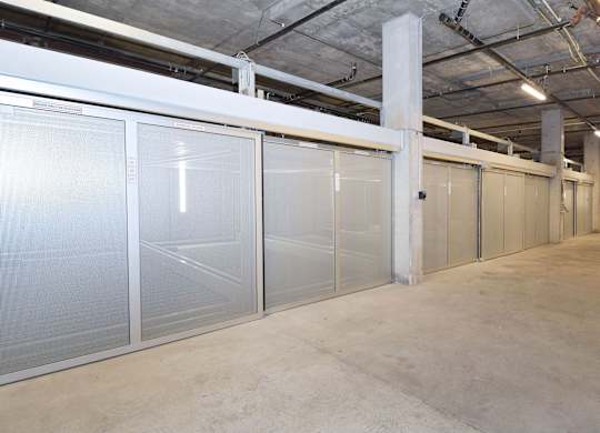a row of stainless steel doors in a warehouse
