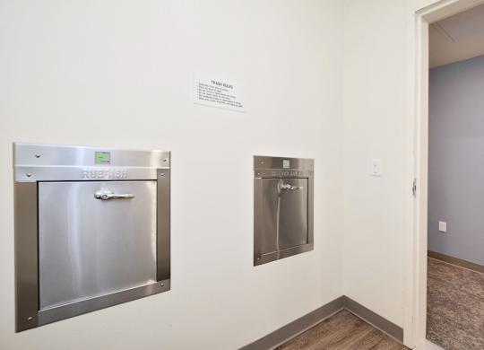 a kitchen with stainless steel appliances and a sign on the wall