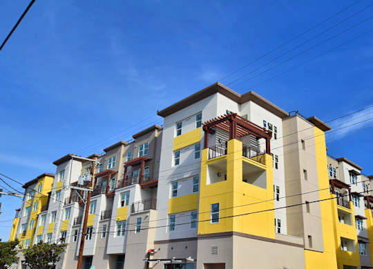 a colorful apartment building with power lines in front of it