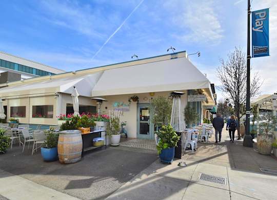 A white building with a blue sign that says