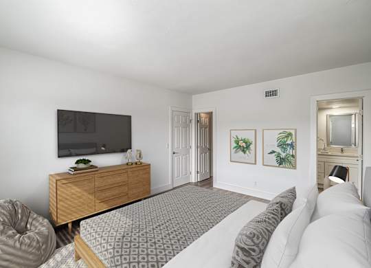 a bedroom with a large bed and a tv
