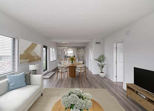 a living room and dining room with a table and chairs