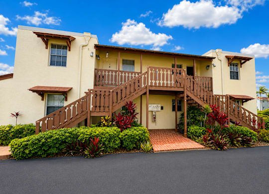 475 - A two-story house with a red brick walkway leading to the front door.