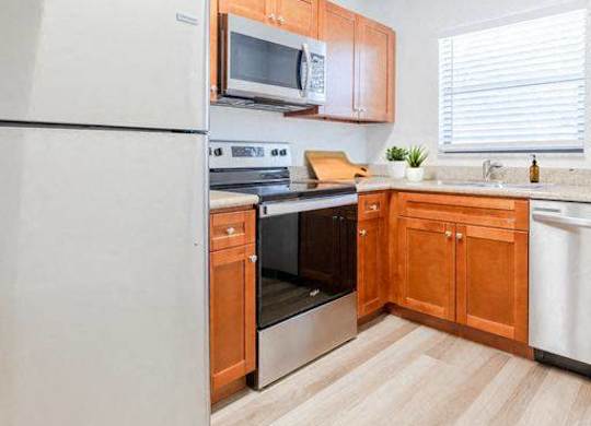 a kitchen with white appliances and wooden cabinets