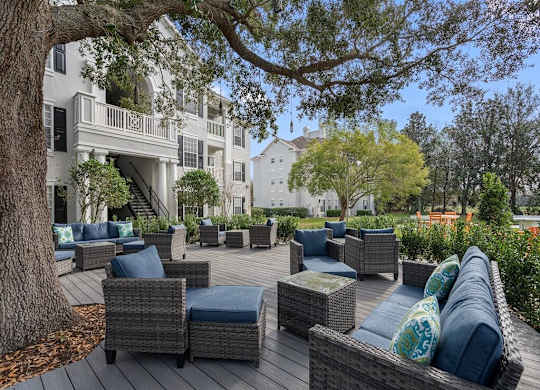 Quiet patio with seating under the shade of a large oak tree