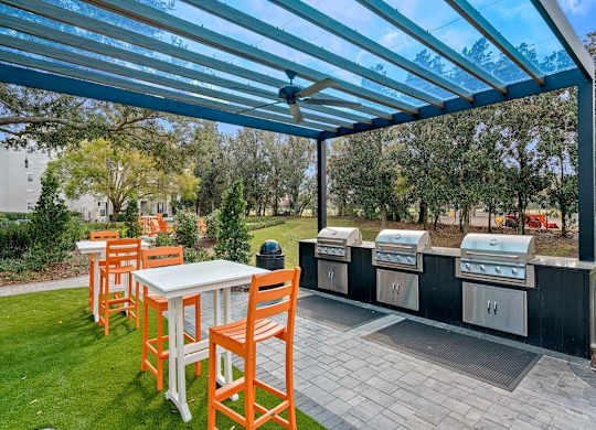 a patio with a table and chairs under a blue roof