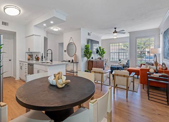 a living room with a dining room table and a kitchen
