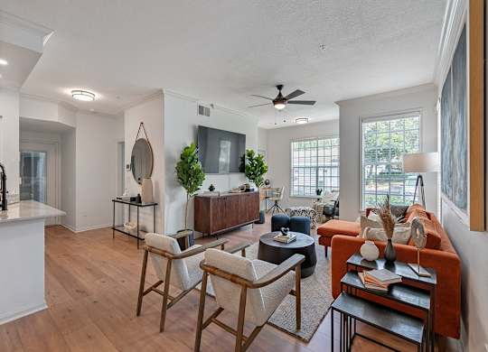a living room with furniture and a ceiling fan