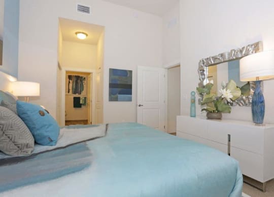 a bedroom with a bed and a dresser and a mirror