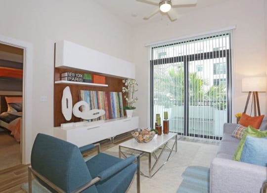 a living room with furniture and a sliding glass door