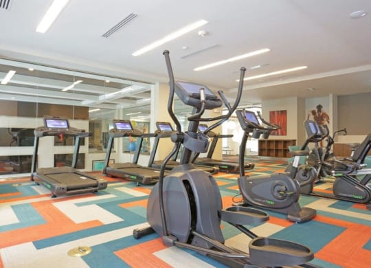 a gym with various exercise equipment in a room