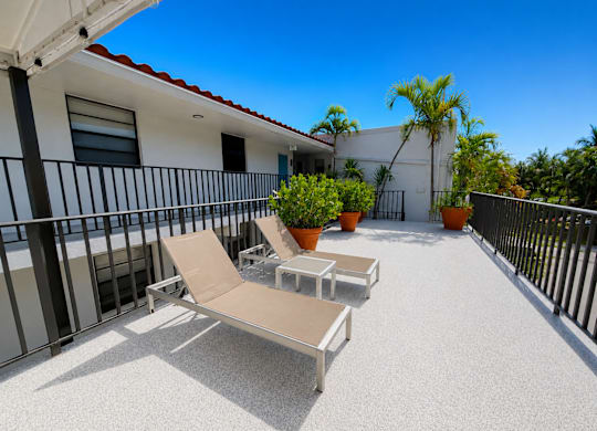 A patio with two chairs and a table.
