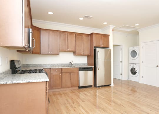 a kitchen with brown cabinets and a white washer and dryer