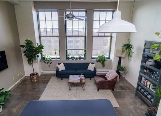A living room with a blue couch and a coffee table.