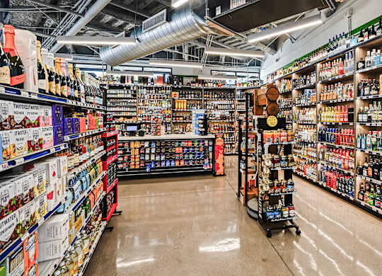 A liquor store with a variety of bottles on the shelves.