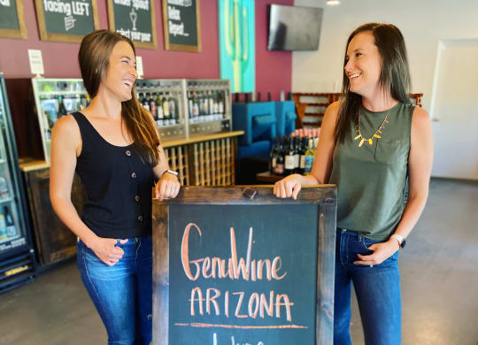 Ladies Standing By GenuWine Sign