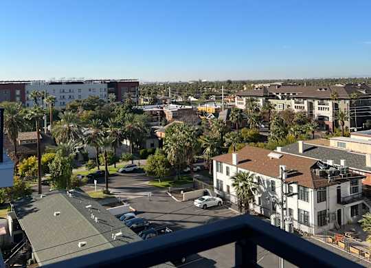 a view of the city from the balcony of a condo