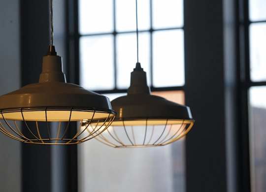 a couple of hanging lights in front of a window
