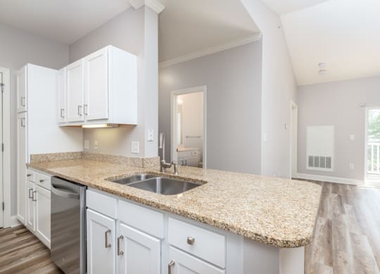 Drum Hill 2 Bedroom Apartment Kitchen with granite countertops, white cabinetry and large family room