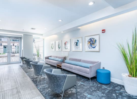 with couches and chairs and a lobby area with paintings