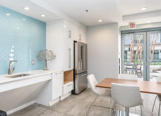 50 WB community space with a kitchen and dining area with a table and chairs