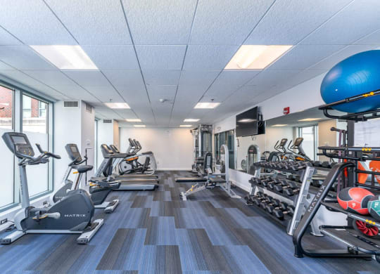 50 WB's gym with cardio equipment and weights in a building with windows