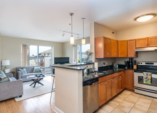 50 WB's model apartment showing kitchen with an island and a living room with a couch