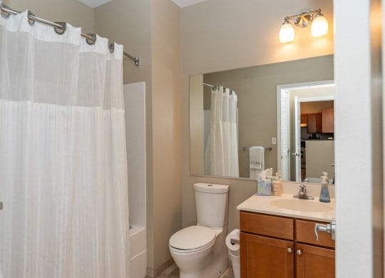 50 WB's furnished apartment showing a bathroom with a shower and a toilet and a sink