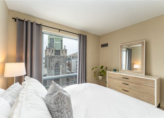 50 WB's furnished apartment showing a bedroom with a bed and a view of a church