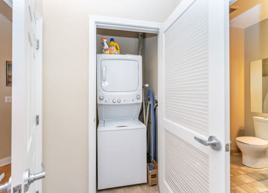 50 WB's furnished apartment showing a small laundry room with a washer and dryer in it