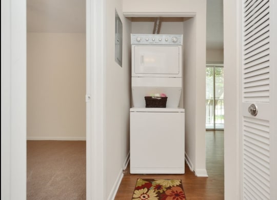 A laundry room with a washer and dryer at Aqua Bay Apartments in Naples, FL 34116