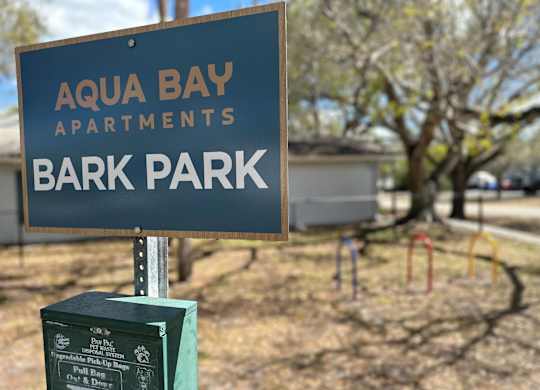 a sign for the Bark Park at Aqua Bay Apartments in Naples, FL 34116