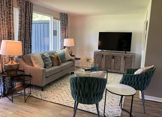 a living room with a couch and a tv at Townhomes at 28th, Columbus, Indiana