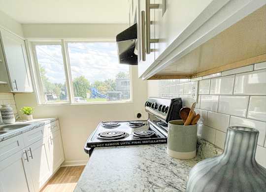 a kitchen with a marble counter top and a stove at Townhomes at 28th, Columbus, IN, 47201