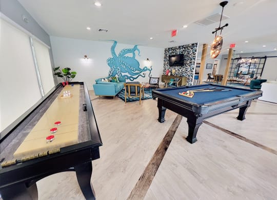 a game room with two pool tables and a tv