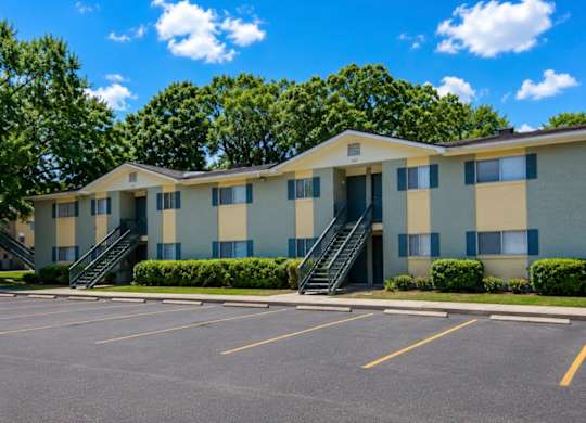 A large building with a parking lot in front of it.