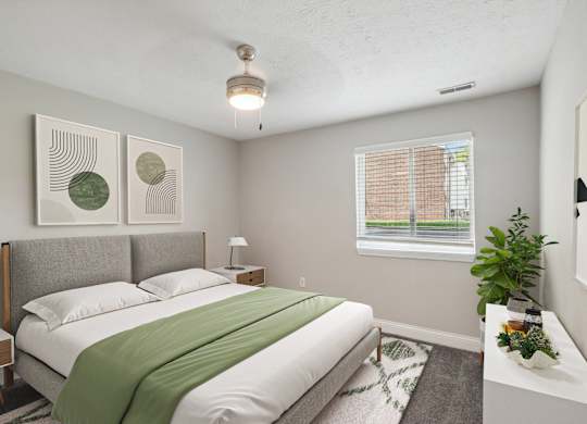 A bedroom with a bed, nightstand, and window.