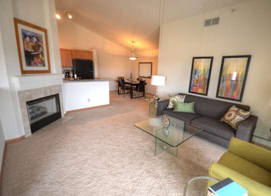 a living room with a couch and a table and a fireplace