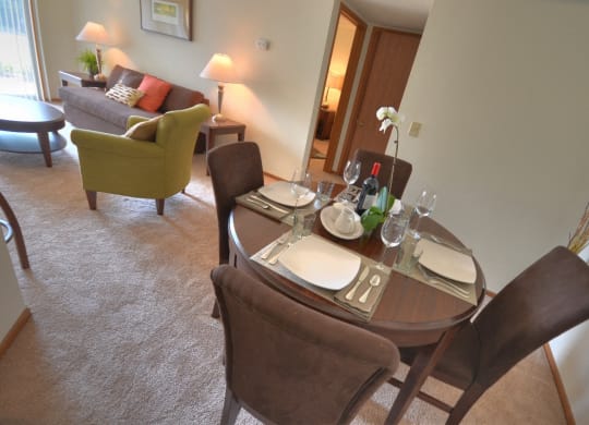 a dining room with a table and chairs in a hotel room