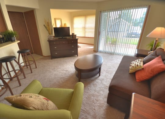a living room with a couch and a chair and a tv