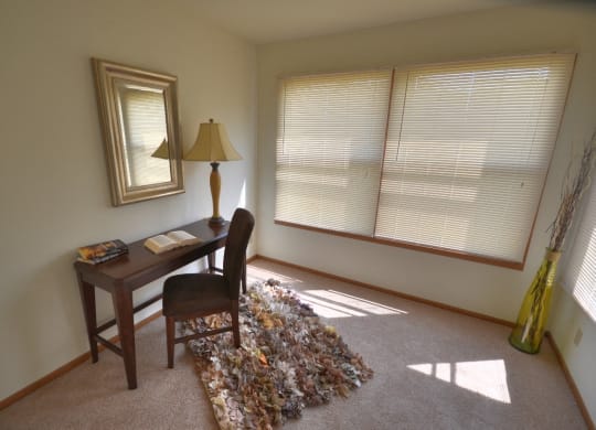 a home office with a desk and a lamp